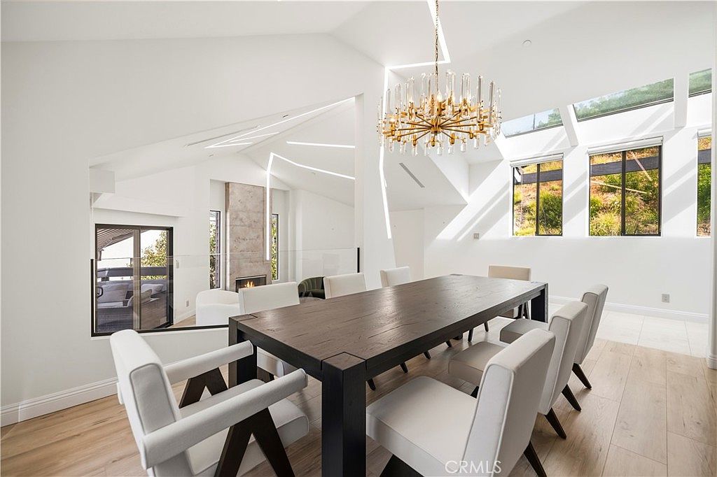 Formal dining room with brass crystal chandelier and dark walnut table