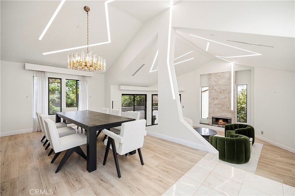 Open floor plan from dining room toward the living room and fireplace
